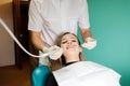 Dentist removes tartar from his patientÃ¢â¬â¢s teeth